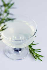 Lemon and rosemary alcoholic drink on white