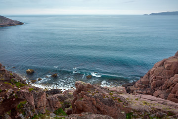 View on the rocky shore of the Barents sea. Kola Peninsula, The Arctic, Russia.