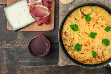 Spanish tortilla in tortillera, with wine, jamon, and cheese