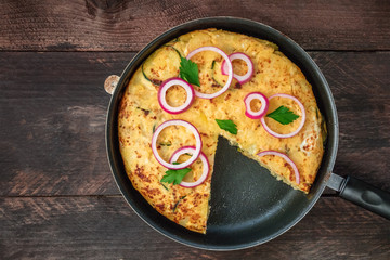 Spanish tortilla in tortillera with copy space, top view