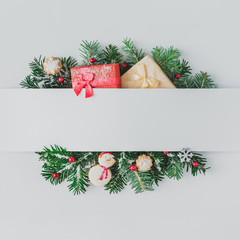 Creative layout made of Christmas tree branches with decoration and snow. Flat lay. Nature New Year concept.