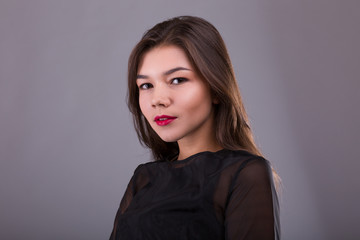 Fototapeta premium Beautiful brunette model: classic makeup and red lips. The beauty face.