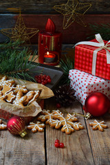 Christmas composition with gingerbread cookies, gifts, festive decoration and fir tree branch. Holiday, New Year, Xmas concept. Vintage style. Flat lay, top view, with copy space.
