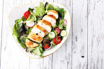 Chicken salad with leaf vegetables and cherry tomatoes.