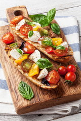 Bruschetta with tomatoes, mozzarella and basil