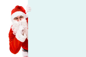 Santa Claus with finger on lips asking for silence, isolated on white background