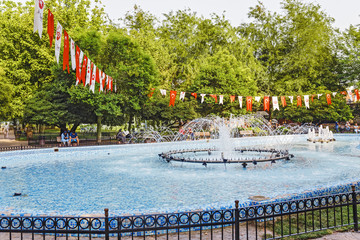 Fototapeta na wymiar Summer park Kadirga in Istanbul with turkish flags and resting people