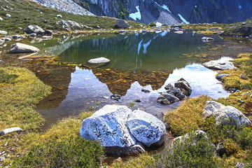 Goat Ridge Landscape Panorama reflected in small lake on great hiking trail in Coast Mountains above Sea to Sky Gondola near Squamish, British Columbia, Canada