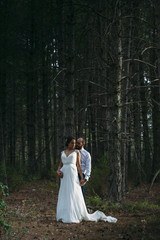 Bride and groom embracing in the park