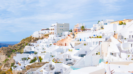 Panorama ofOia town on Santorini island, Greece. Traditional and famous white and rose  houses over...