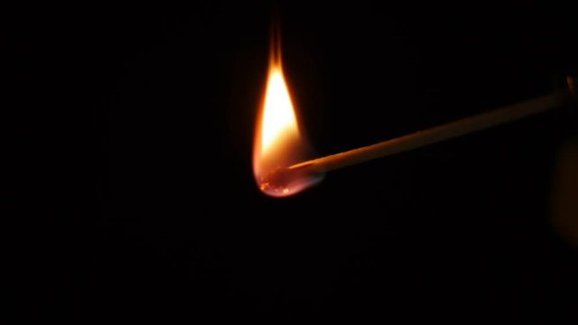 Slow motion of lighting a match with black background