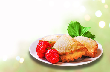 Festive cookies with strawberries on a background of lights