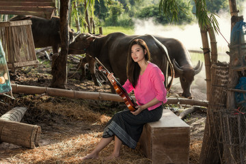 Rural women playing violin at countryside,Playing music is the relaxation of rural girl in Asia.