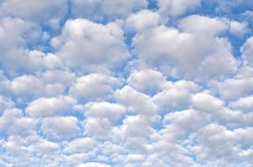 white cumulus clouds on a blue sky