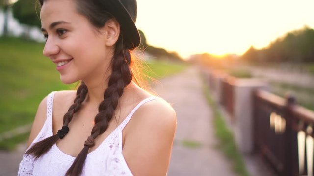 Portrait of young smiling girl in clothing fashion hat outdoors
