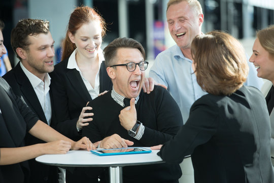 Business People Congratulating Coworker