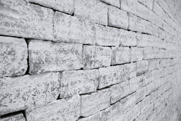 uneven masonry Brick wall in black and white selective focus taken from a side