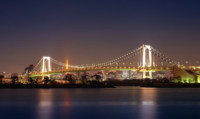 Fototapeta na wymiar Night view Rainbow Bridge and Tokyo City Skyline background, Odaiba
