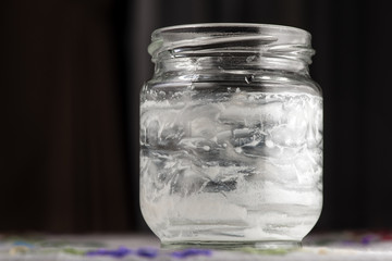 Empty yogurt jar isolated on black background