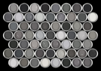 Tins of paint in various shades of grey.