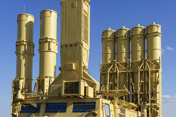 Antiaircraft missile complex, ballistic launcher with big missiles ready to attack on military powerful transportation with blue sky on background, modern army industry