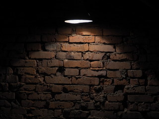 old wall lantern     .The old brick wall is lit by a flashlight