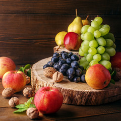 Still life of fruit, apples, pears, grapes and nuts. Copy space. The concept is healthy food, vegetarianism, vitamins.