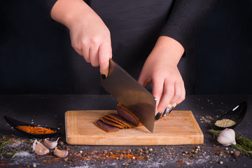 the woman cuts meat dried or smoked