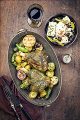 Barbecue leg of lamb with vegetable, potatoes and feta as top view in a casserole