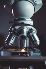 Close-up shot of microscope with metal lens at laboratory.