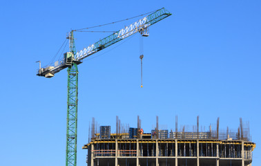 Residential buildings construction site with three working tower cranes background