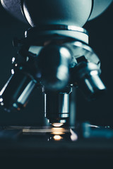 Close-up shot of microscope with metal lens at laboratory.