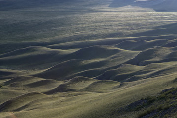 Wavy landscape with a low sun. Steppes Of Khakassia. Russia.