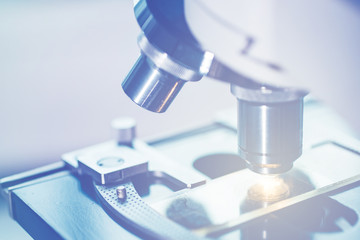 Close-up shot of microscope with metal lens at laboratory.