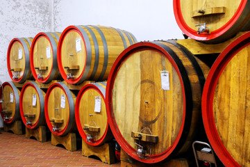 Wooden barrels in a wine cellar in Montalcino, Val d'Orcia, Tuscany, Italy