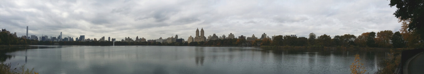 Panorama of a Cityscape across the lake on an overcast day at the park