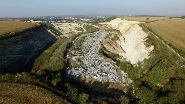 Aerial shot of garbage dump between agricultural fields.