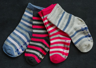 Various colors of child's striped socks.