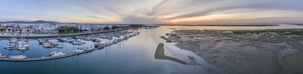 Sunrise aerial seascape view of Olhao Marina, waterfront to Ria Formosa natural park. Algarve.