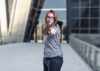 Pretty young business woman presenting something with black glasses