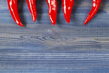 cayenne chilli peppers on wooden table