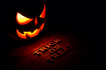 The concept of Halloween. Glowing with hot light angry terrible pumpkin. jack lantern in the dark,...