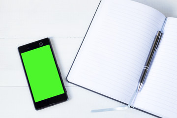 smartphone with green screen and open notepad