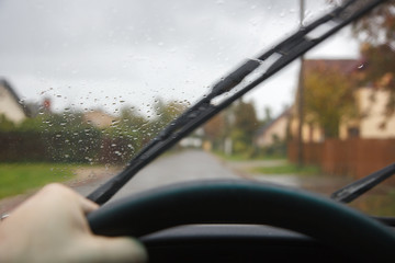 driving car in rainy day windshield cleaners working