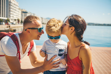 Father, mother and son eating ice cream, sunny summer. Summer, holidays, sea, tourism and people concept. Fashion.