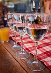 Row of pure drinking water glasses at summer terrace cafe.