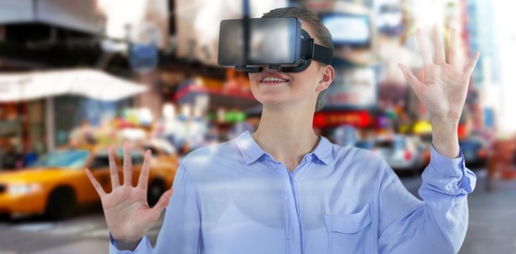 Composite image of businesswoman experiencing virtual reality