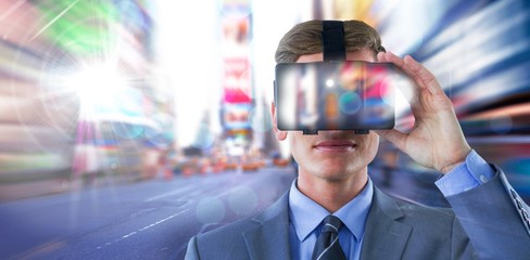 Composite image of businessman in suit using virtual reality