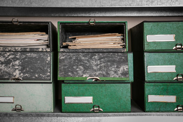 Cardboard boxes with documents on shelving unit in archive