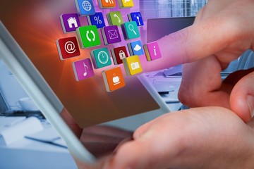 Composite image of hands using tablet with digital effects